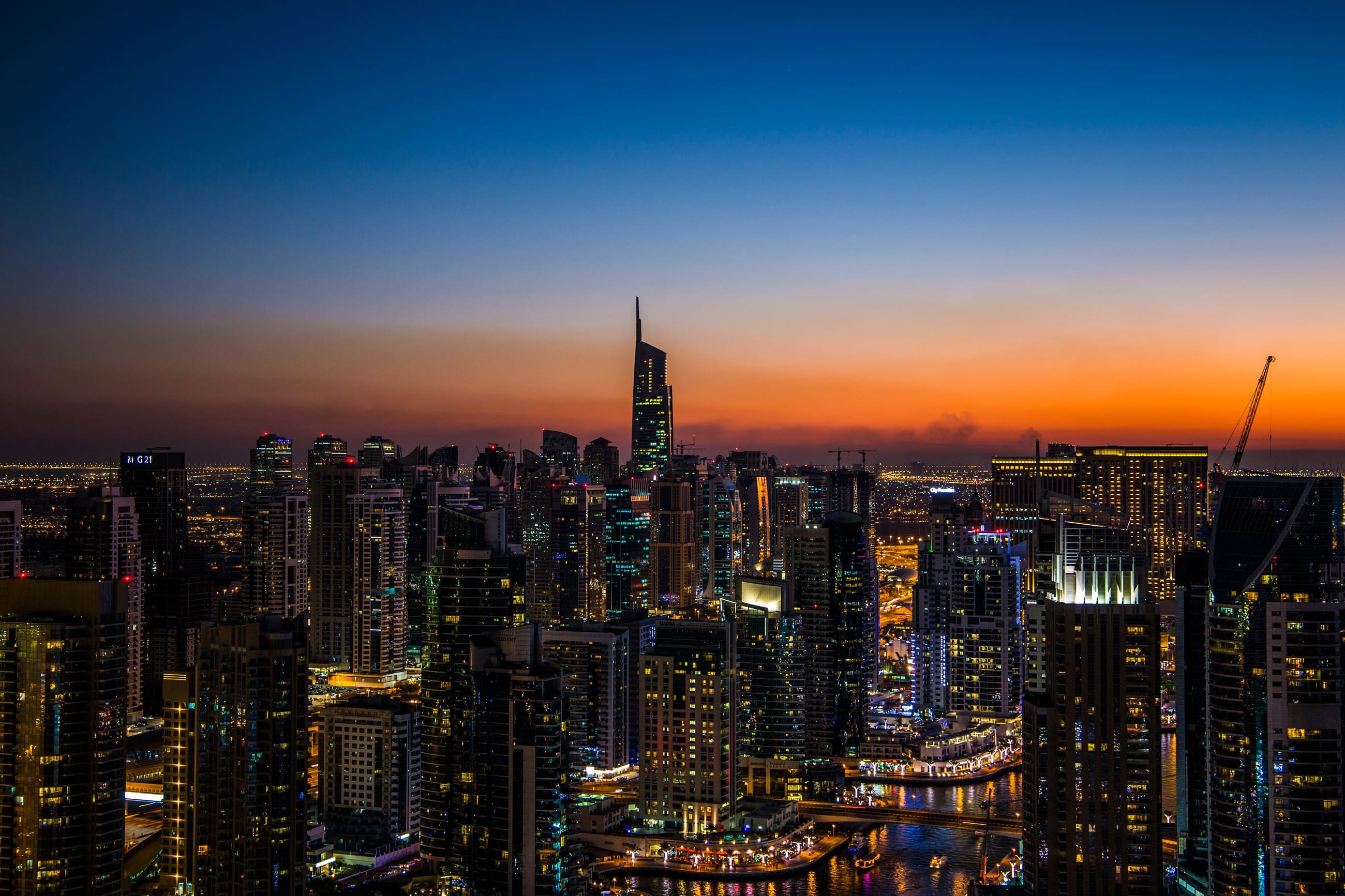 Dubai skyline at sunset, palace hotel in the foreground.
