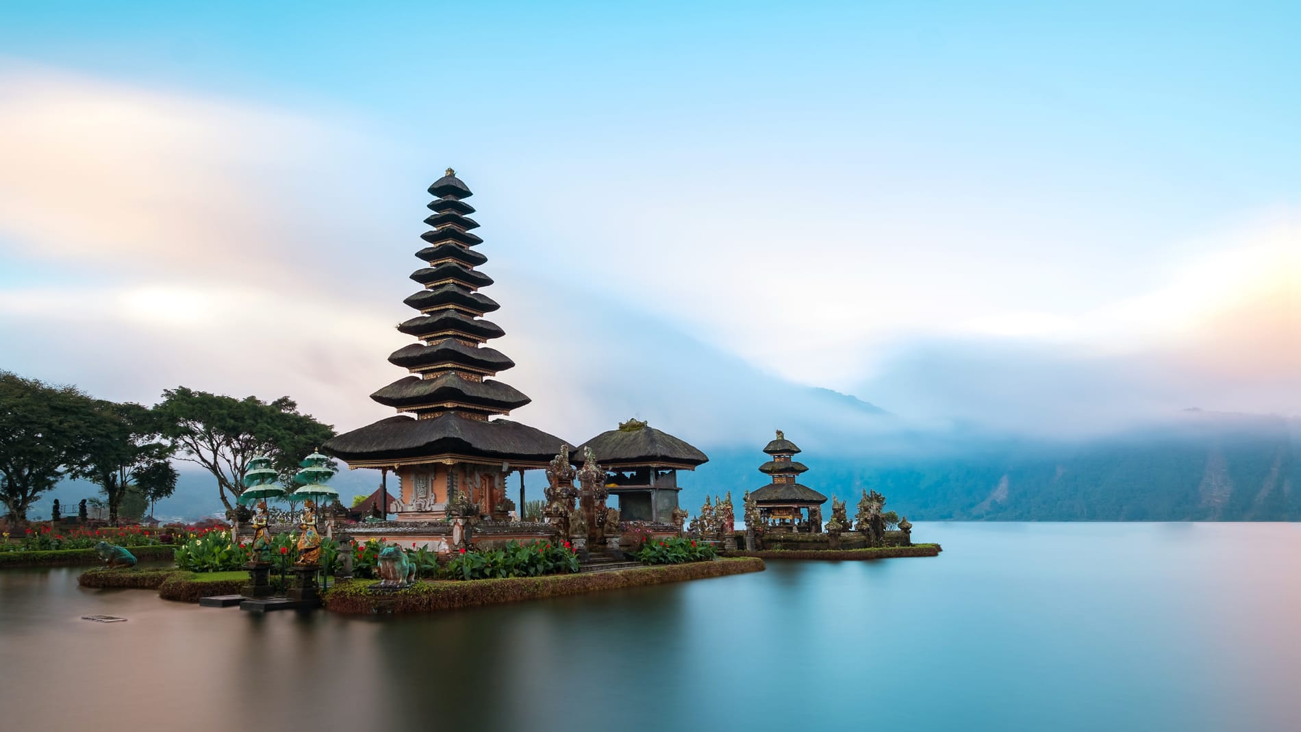 Balinese villa facing the ocean at dawn.